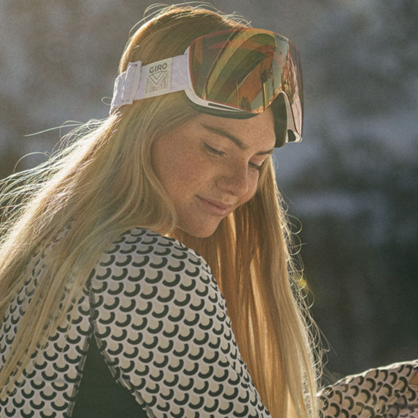 Female Snowboarder on a mountain wearing baselayer and goggles