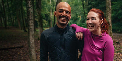 Two people in the woods wearing baselayers