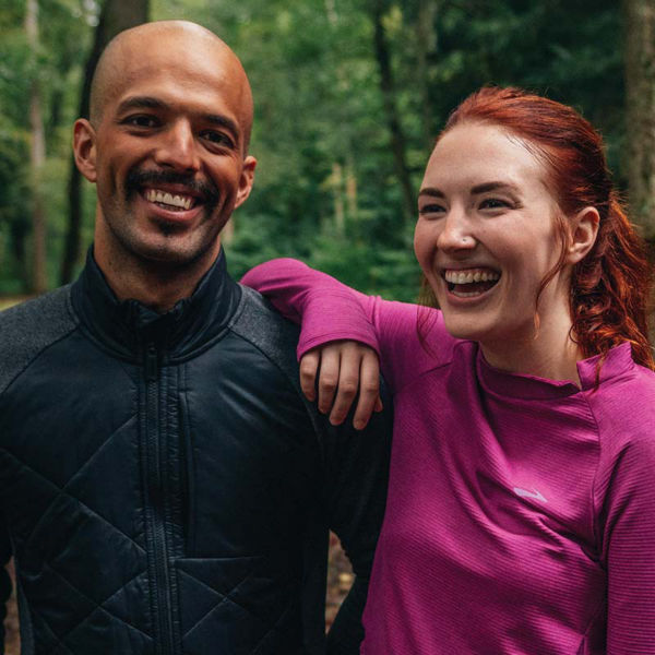 Two people in the woods wearing baselayers