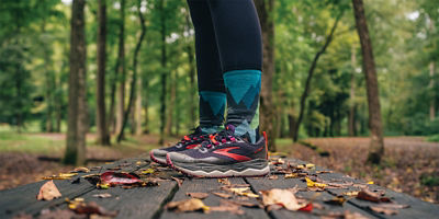 Close up of someone standing on a bench in the woods