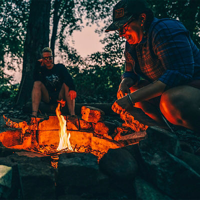 Two women prepare a fire on Sycamore Island