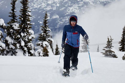 Man snowshoeing in the mountains. 