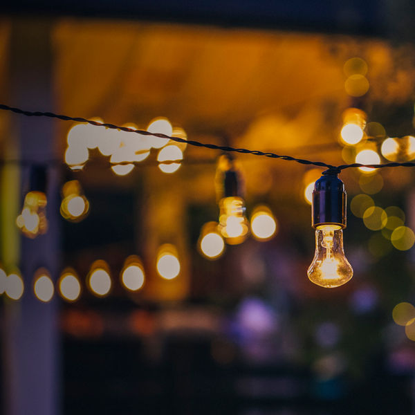 outdoor string lights hanging on a line in backyard