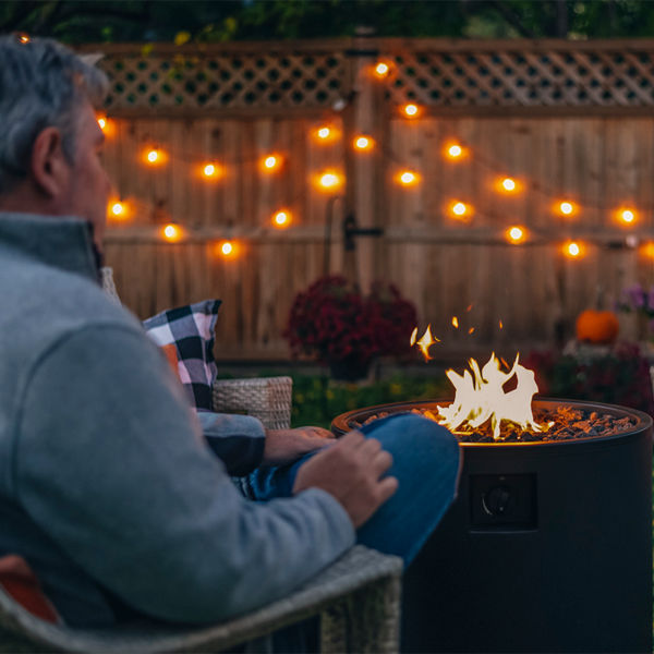 Man relaxing in the backyard by a fire