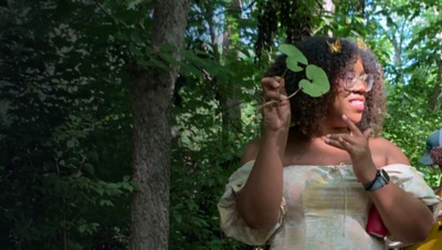  Black Forager Alexis Nikole Nelson poses with a plant in the woods
