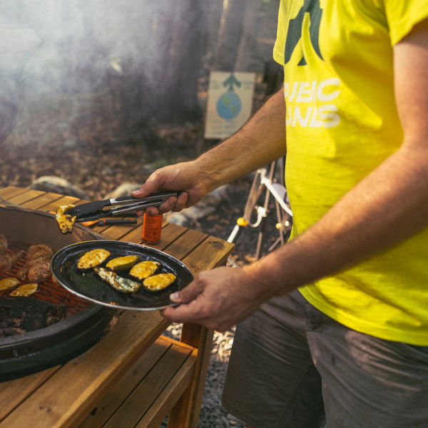 A man grills outside