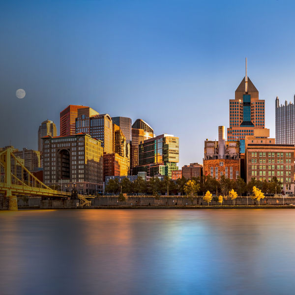 Long exposure of Pittsburgh downtown skyline and Roberto Clemente bridge, on a sunny afternoon, as viewed from North Shore Riverfront Park, across Allegheny River. 