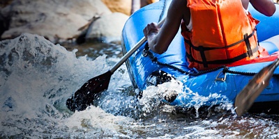 Close-up of young person rafting on the river