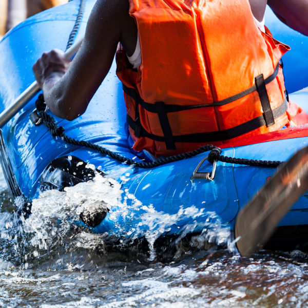 Close-up of young person rafting on the river