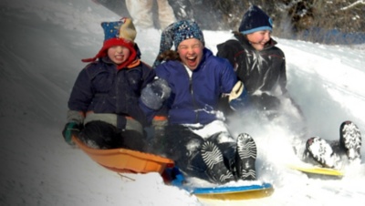 kids sledding down a hill