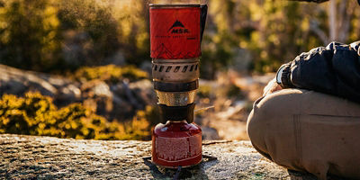 Closeup of gas cooking device at a campsite
