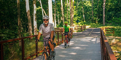 Two bikers on a bridge along Camp Chase Trail in Battelle Darby Creek Metro Park