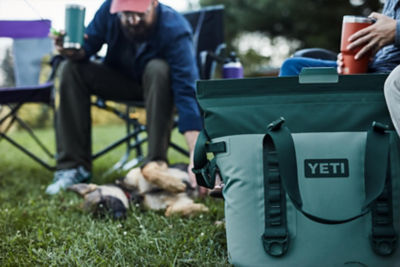 Yeti cooler set outside with camping group
