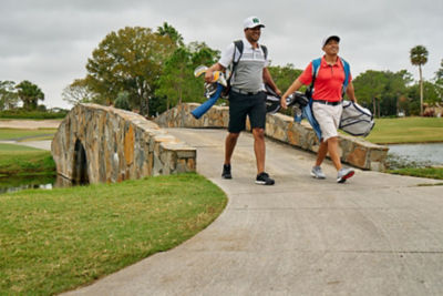An image of two golfers walking on the course. 