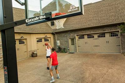 Family playing basketball in their driveway