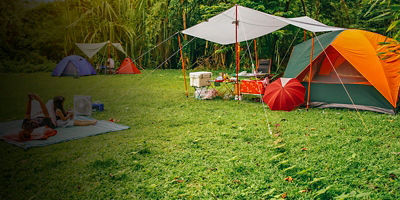 nature landscape camping tent with tarp and child family under tree on green grass meadow in jungle garden or forest for vacation picnic on holiday relax travel and summer or rainy with sunlight