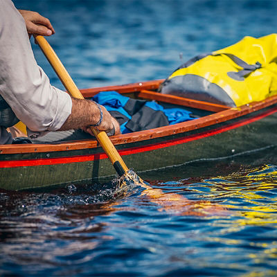 A man paddles on Flagstaff Lake, Maine