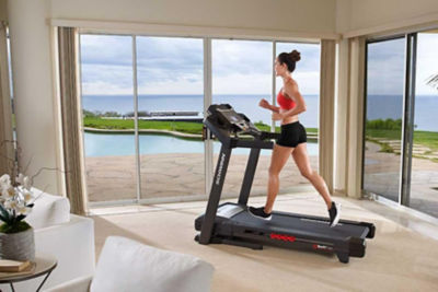 Woman running on treadmill in her home