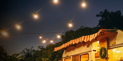 A  view of motorhome outdoors at night with lights