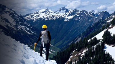 Man Alpinist Standing on top of Ruth Mountain