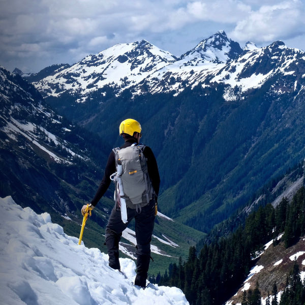 Man Alpinist Standing on top of Ruth Mountain