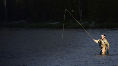 Woman fly fishing in the Firehole River.