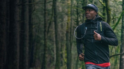 A runner runs through the forest