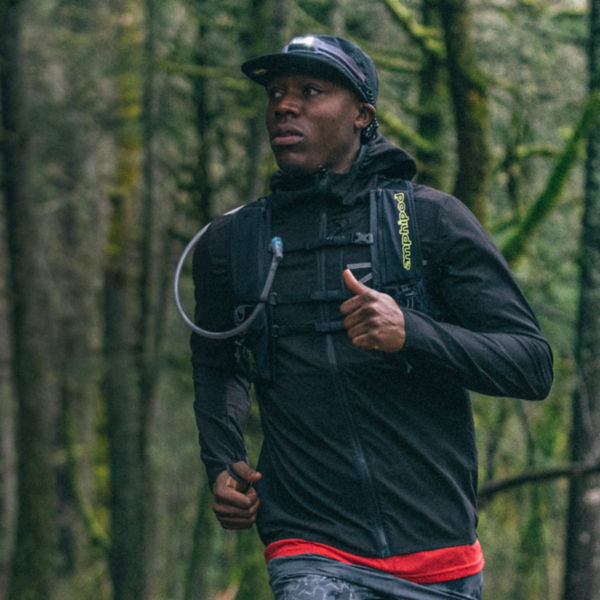 A runner runs through the forest