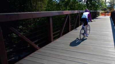 A man bikes the Bear Creek Greenway