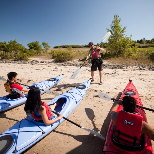 A guide teaches kayak tours