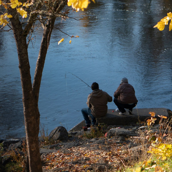 Two people fishing on the Rogue River in Southern Oregon on a autumn morning.