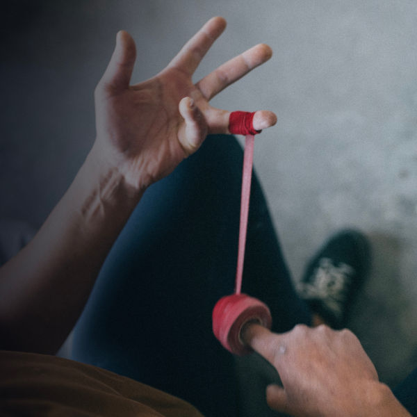 A detail of a climber applying climbers tape to hands