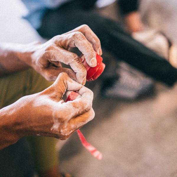 A detail of a climber applying climbers tape to hands