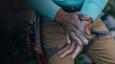 A detail of a climbers hands with chalk 