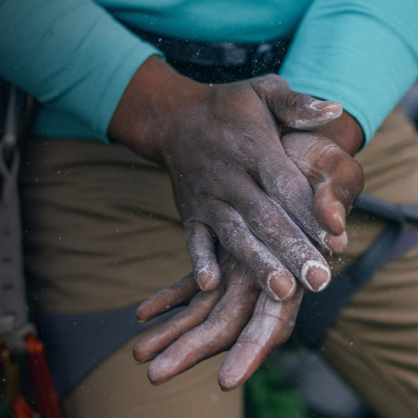 A detail of a climbers hands with chalk 