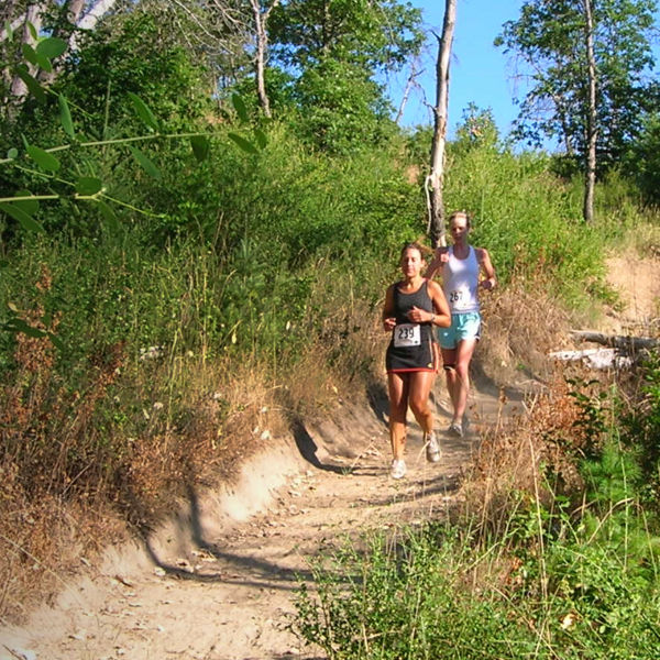 Two people run a race at Jackson Forest Park Trail 