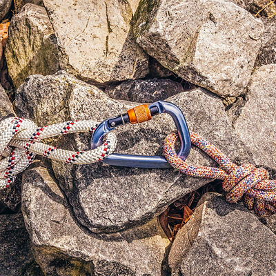 Two climbing ropes with knots connected with carabiner