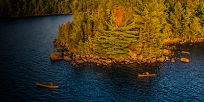 Aerial drone view of paddling at Hurricane Island on Flagstaff Lake, Maine along the Northern Forest Canoe Trail 