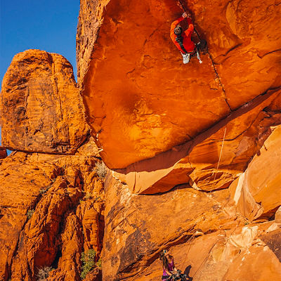 A photo of Chris Weidner on a climb being belayed by Heather Weidner