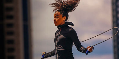 A woman working out with jump rope outdoors