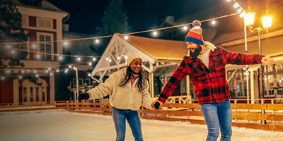 Man holding hand of his girlfriend while ice skating