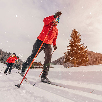 Man cross-country skiing during sunny winter day.