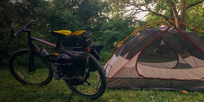 A bikepacking bike sits next to a tent at Roundbottom Campground