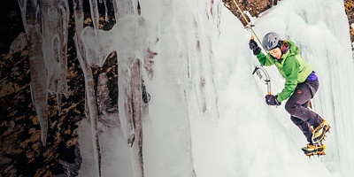 A woman is ice climbing in New Zealand, Otago, Wye Creek basin.