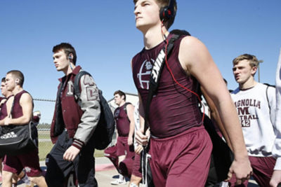 An image of football players walking to practice. 