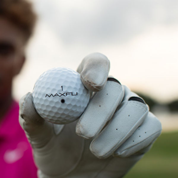 A man holding a golf ball.