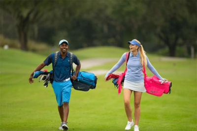 Golfers walking on course converstating.