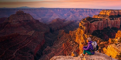 Hiker at sunrise at Cape Royal overlook, North Rim, Grand Canyon National Park, AZ