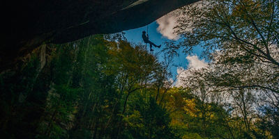 A person rappels Big Spring Hollow Waterfall 