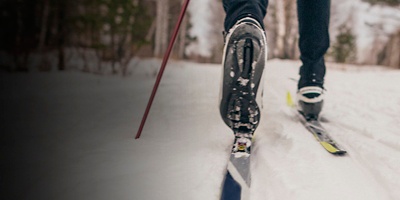 A close up of a cross country skiier boot and ski